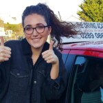 girl in front of red car